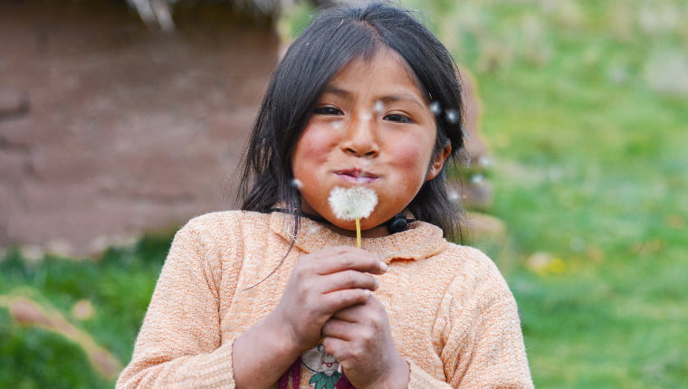 a little girl holding a flower