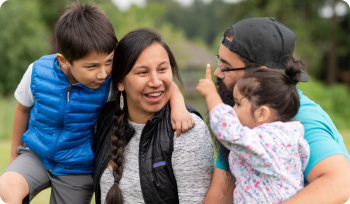 an Indigenous family laughing together